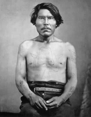 Haida chief with codfish tattoo on torso and other markings, ca. 1870.