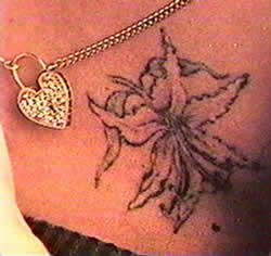 Cher's black orchid tattoo detail