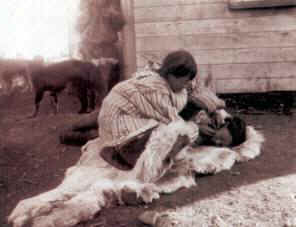 Asiatic Eskimos"stitching the skin" at Indian Point, Chukotka, 1901.
