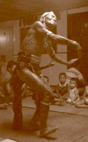 Iban elder doing traditional war dance