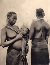 Two Makonde women & one with elaborate back tattooing 