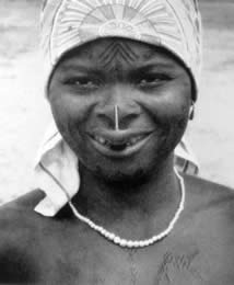 Makonde women with ndona (labret), forehead, chin, cheek, and sternum tattoos.