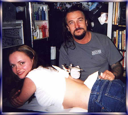 Christina Ricci getting sweet peas tattooed on her lower back by Thomas Lockhart at his West Coast Tattoo in Vancouver, BC, Canada