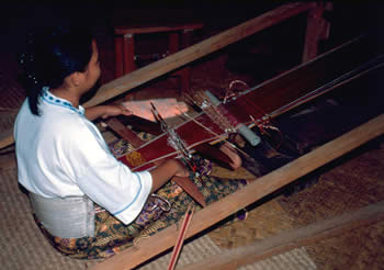 Young Iban woman weaving a ceremonial headband