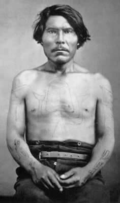 Haida chief with codfish tattoo on torso and other markings, ca. 1870.